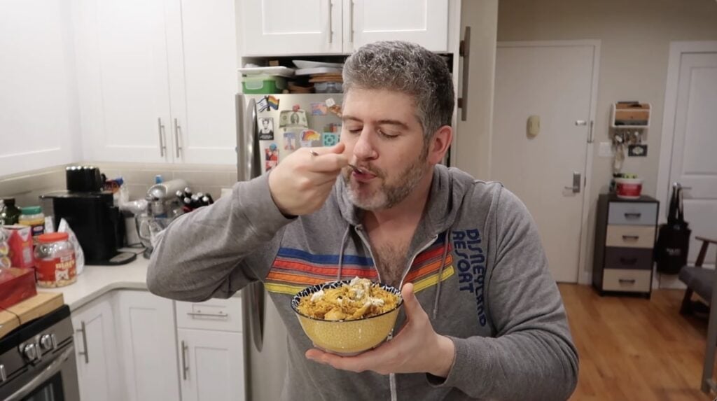 Man trying Chicken Biryani